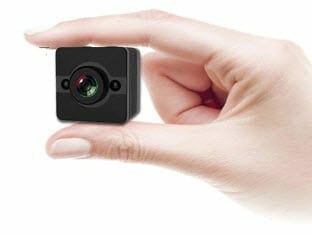 person holding a mini camera