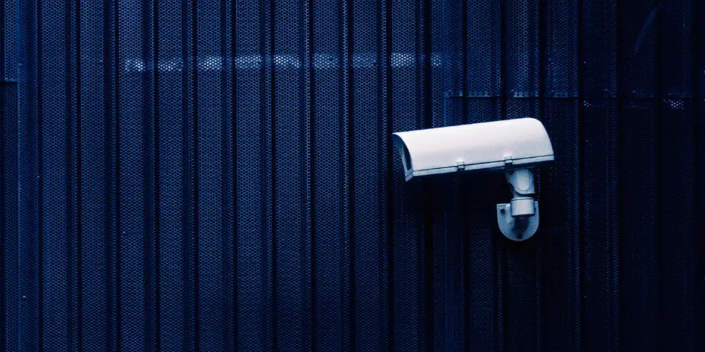 a surveillance camera mounted on a building's wall outside