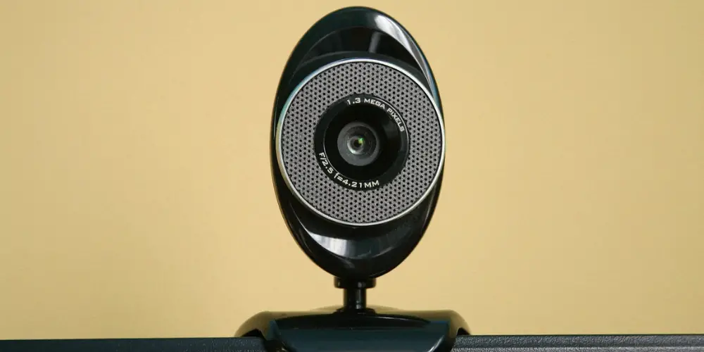 a webcam in a yellow wall background