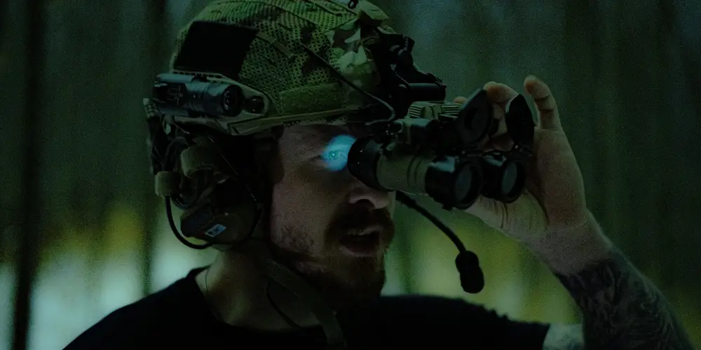 a man holding a night vision device