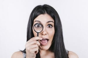 a woman holding magnifying glass